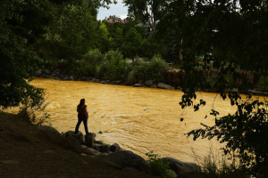 DURANGO, CO - AUGUST 7: Kalyn Green, resident of Durango, stands on the edge of the river August 6, 2015 along Animas River. "I come down to the river every morning before work." said Green. "The river in a sense of calm for me." Over a million gallons of mine wastewater has made it's way into the Animas River closing the river and put the city of Durango on alert. (Photo By Brent Lewis/The Denver Post via Getty Images)